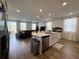 Bright living space with a kitchen island, stainless steel appliances, and ample lighting at 2086 Crape Jasmine Ln, Orlando, FL 32824