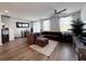 Cozy living room showcasing a comfortable sectional sofa and wood-look flooring at 2086 Crape Jasmine Ln, Orlando, FL 32824