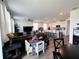 Open-concept living area with a large sectional sofa, kitchen, and dining space at 2086 Crape Jasmine Ln, Orlando, FL 32824
