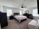 Spacious main bedroom featuring a ceiling fan, ensuite, and carpeted floors at 2086 Crape Jasmine Ln, Orlando, FL 32824