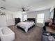 Spacious main bedroom featuring a ceiling fan, ensuite, and carpeted floors at 2086 Crape Jasmine Ln, Orlando, FL 32824