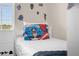 Bedroom featuring bright bedding with superhero decor and natural light from the windows at 2307 Silver Palm Dr # 304, Kissimmee, FL 34747