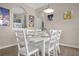 Bright dining room featuring a white wood table and chairs, with a view into the kitchen at 2307 Silver Palm Dr # 304, Kissimmee, FL 34747