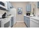 Efficient kitchen featuring blue cabinets and white appliances at 2307 Silver Palm Dr # 304, Kissimmee, FL 34747