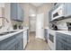 Stylish kitchen with blue cabinets and stainless steel appliances at 2307 Silver Palm Dr # 304, Kissimmee, FL 34747