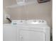 Bright laundry room featuring a washer and dryer and a shelf at 2307 Silver Palm Dr # 304, Kissimmee, FL 34747