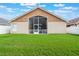 Home exterior view showcases lawn and screened lanai at 2912 Lazlo Ln, Orlando, FL 32837