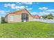 Expansive backyard featuring a screened lanai, lush green grass, and a white picket fence at 2912 Lazlo Ln, Orlando, FL 32837