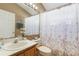 Well-lit bathroom features vanity and floral shower curtain at 2912 Lazlo Ln, Orlando, FL 32837