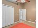 Neutral bedroom features vaulted ceilings, ceiling fan and double door closet at 2912 Lazlo Ln, Orlando, FL 32837