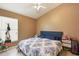 Neutral bedroom features window for natural light and blue accents at 2912 Lazlo Ln, Orlando, FL 32837