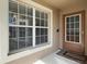 Welcoming front entrance with a window, security system, and a dark-stained front door with glass panes at 2912 Lazlo Ln, Orlando, FL 32837