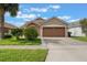 Charming single-Gathering home with a well-manicured lawn, lush landscaping, and a two-car garage at 2912 Lazlo Ln, Orlando, FL 32837