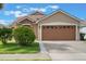 Charming single-Gathering home featuring a two-car garage, manicured lawn, and a welcoming facade at 2912 Lazlo Ln, Orlando, FL 32837