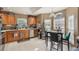 Bright kitchen featuring light tile floors, wood cabinets, stainless steel appliances, and a dining area at 2912 Lazlo Ln, Orlando, FL 32837