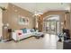 Open living room boasts tile flooring, vaulted ceiling, and access to the patio at 2912 Lazlo Ln, Orlando, FL 32837
