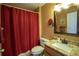Functional bathroom featuring a shower, a granite vanity, and warm lighting at 3030 Eagle Crossing Dr, Kissimmee, FL 34746