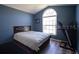 Inviting bedroom featuring a large window, a bed and a treadmill at 3030 Eagle Crossing Dr, Kissimmee, FL 34746