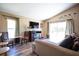 Bright living room boasts large windows, a fireplace, and comfortable seating at 3030 Eagle Crossing Dr, Kissimmee, FL 34746