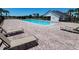 Resort-style community pool with lounge chairs and sun deck, perfect for relaxation and recreation at 3030 Eagle Crossing Dr, Kissimmee, FL 34746