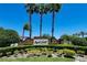 Community entrance sign amidst lush landscaping, welcoming residents and guests to the neighborhood at 3030 Eagle Crossing Dr, Kissimmee, FL 34746