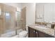 Bathroom with walk-in shower, granite counters, dark cabinets, and white towels at 340 Pendant Ct, Kissimmee, FL 34747