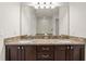 Bathroom featuring double sinks with granite countertops and dark wood cabinets at 340 Pendant Ct, Kissimmee, FL 34747