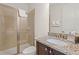Bathroom with walk-in shower, granite counters, dark cabinets, and white towels at 340 Pendant Ct, Kissimmee, FL 34747