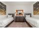 Shared bedroom with two twin beds, dresser with lamps, and decorative artwork at 340 Pendant Ct, Kissimmee, FL 34747