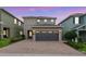 Charming home with a two-car garage, brick driveway, and manicured landscaping at 340 Pendant Ct, Kissimmee, FL 34747