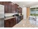The kitchen features granite countertops, wood cabinetry, and modern appliances for a stylish design at 340 Pendant Ct, Kissimmee, FL 34747