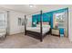 Spacious bedroom with a four-poster bed, turquoise accent wall, and natural light at 340 Pendant Ct, Kissimmee, FL 34747