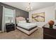 Main bedroom features accent wall, stylish lighting, and windows overlooking the backyard at 340 Pendant Ct, Kissimmee, FL 34747