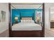 Inviting bedroom featuring a four-poster bed, bedside tables with lamps, and a colorful accent wall at 340 Pendant Ct, Kissimmee, FL 34747