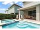 Backyard brick patio with a pool, hot tub, and lounge chairs at 340 Pendant Ct, Kissimmee, FL 34747