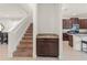 View of staircase with runner, small granite counter, and an entry to the kitchen at 340 Pendant Ct, Kissimmee, FL 34747