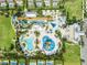 Eye-catching overhead view of a community waterpark, featuring an abundance of pools, slides, and palm trees at 340 Pendant Ct, Kissimmee, FL 34747