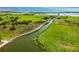 Beautiful aerial view of a green marshland featuring a long boardwalk reaching out to the ocean at 3427 Harborside Ct, Kissimmee, FL 34746