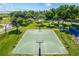 Overhead view of a well-maintained community basketball court surrounded by trees and green space at 3427 Harborside Ct, Kissimmee, FL 34746