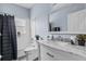 Bright bathroom with a marble countertop vanity, framed mirror, and a shower-tub combo with white tile at 3427 Harborside Ct, Kissimmee, FL 34746