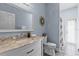 Well-lit bathroom featuring granite countertop vanity, framed mirror, and an enclosed shower at 3427 Harborside Ct, Kissimmee, FL 34746