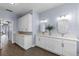 Bathroom with double sinks, white cabinets, and decorative lighting at 3427 Harborside Ct, Kissimmee, FL 34746