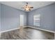 Cozy bedroom with a ceiling fan, tile floors, and a window providing natural light at 3427 Harborside Ct, Kissimmee, FL 34746