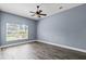Minimalist bedroom with tile flooring, ceiling fan, and a window allowing natural light at 3427 Harborside Ct, Kissimmee, FL 34746