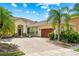 Charming single-story home featuring a brick driveway, mature landscaping, and a well-manicured lawn at 3427 Harborside Ct, Kissimmee, FL 34746
