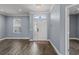 Foyer with hardwood floors, light gray walls, chandelier and view of the front door and entry window at 3427 Harborside Ct, Kissimmee, FL 34746