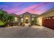Single-story home exterior at dusk featuring a brick driveway, manicured landscaping, and attached garage at 3427 Harborside Ct, Kissimmee, FL 34746