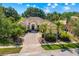 Aerial view of a single-story home showcasing a brick driveway, lush landscaping and beautiful tile roof at 3427 Harborside Ct, Kissimmee, FL 34746