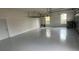 Spacious garage with sealed floor, storage rack, and natural light, perfect for vehicles and hobbies at 3427 Harborside Ct, Kissimmee, FL 34746