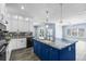 Open floorplan with modern kitchen island, stainless appliances, and an adjacent living space at 3427 Harborside Ct, Kissimmee, FL 34746